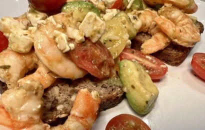 sheet pan shrimp with tomatoes and feta served on toast