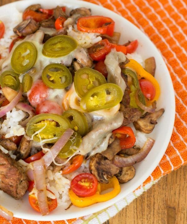 Enjoy a classic sandwich in a new way with these tasty cheesesteak rice bowls!