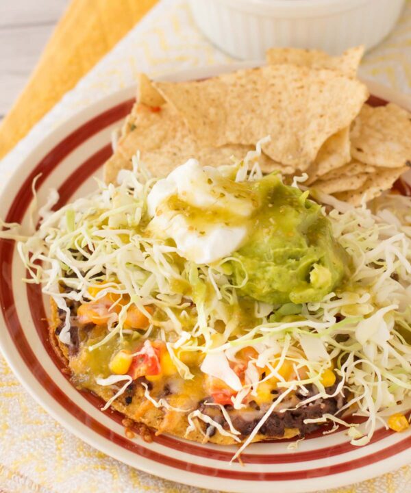 These loaded tostadas topped with easy corn salsa are on the table in about 20 minutes! Perfect quick dinner recipe!